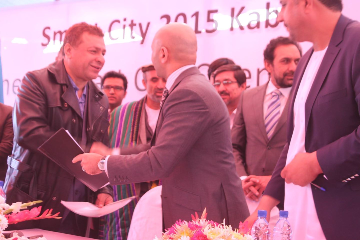 Caption: Convicted Kabul Bank shareholder Khalil Ferozi is treated as a guest of honor during the 4 November 2014 stone-laying ceremony for Kabul's Smart City, where he signs an MoU with the ministry of urban development. Source: ministry of urban development.