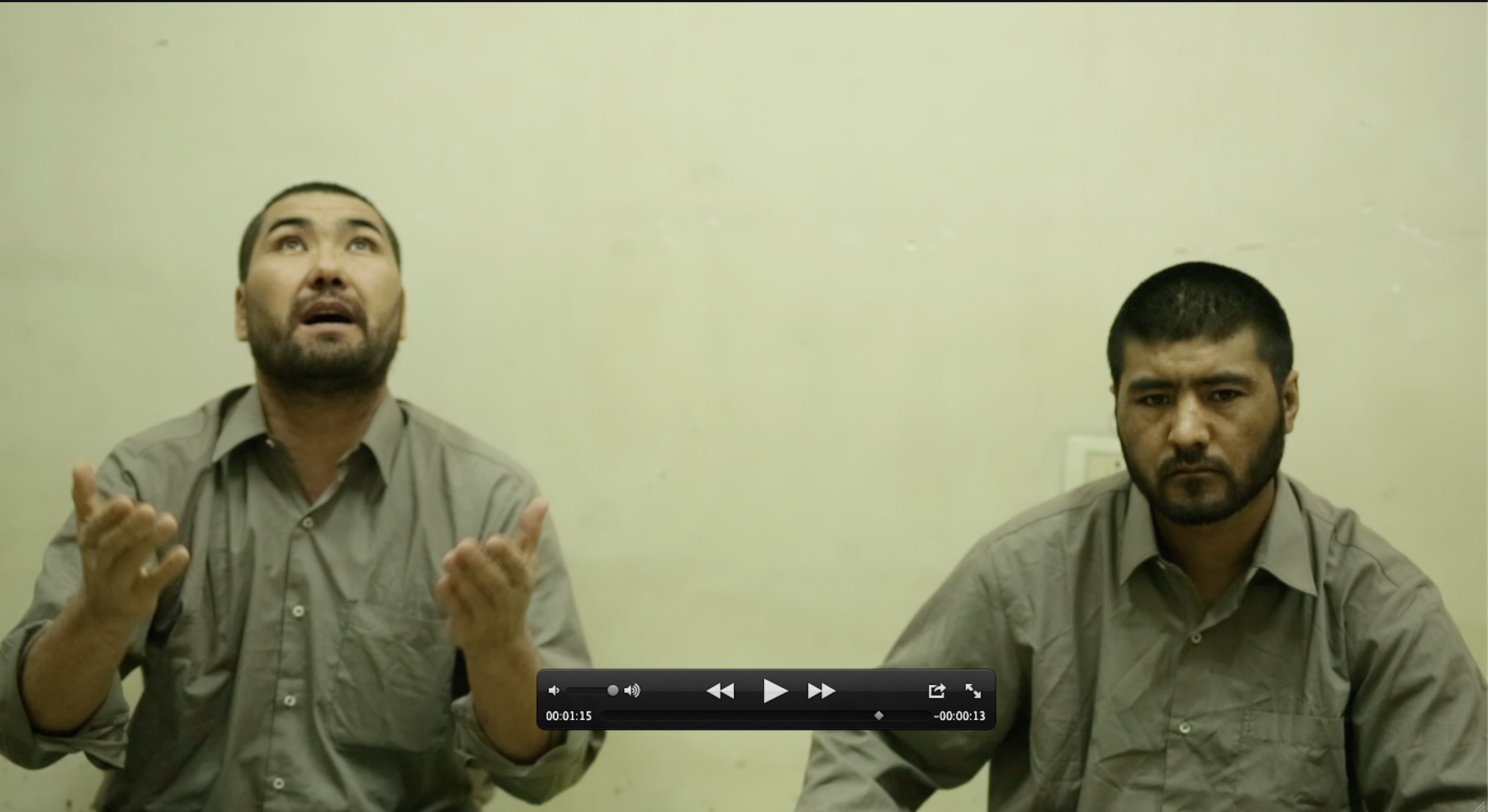 Murad and Sayyed in their neon-lit basement prison in Aleppo, Syria. They are being held by Syrian rebels who want to exchange them, but find no one interested in their prisoners. Photo: screenshot from a video taken by Christoph Reuter