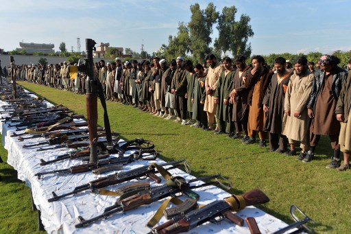 ISKP fighters photographed alongside their captured weapons after their surrender to Afghan government in November 2019. (photo: Noorullah Shirzada/AFP)