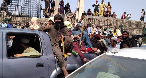Taleban fighters celebrate their capture of Jalalabad, on 15 August 2021. Photo: AFP