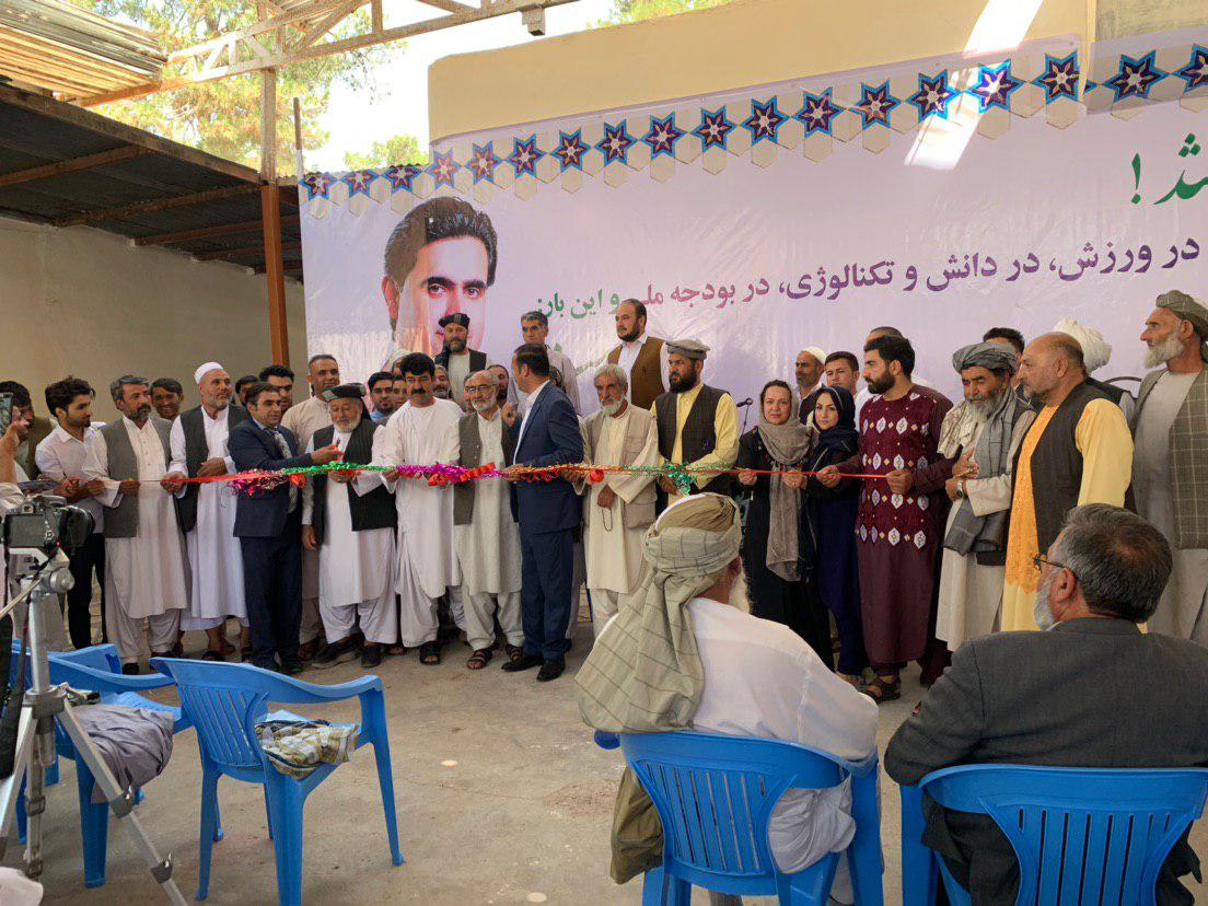 Participants are getting ready to cut a ribbon to open the campaign headquarters of Faramarz Tamanna in Herat city on 22 July 2019. Photo: Reza Kazemi